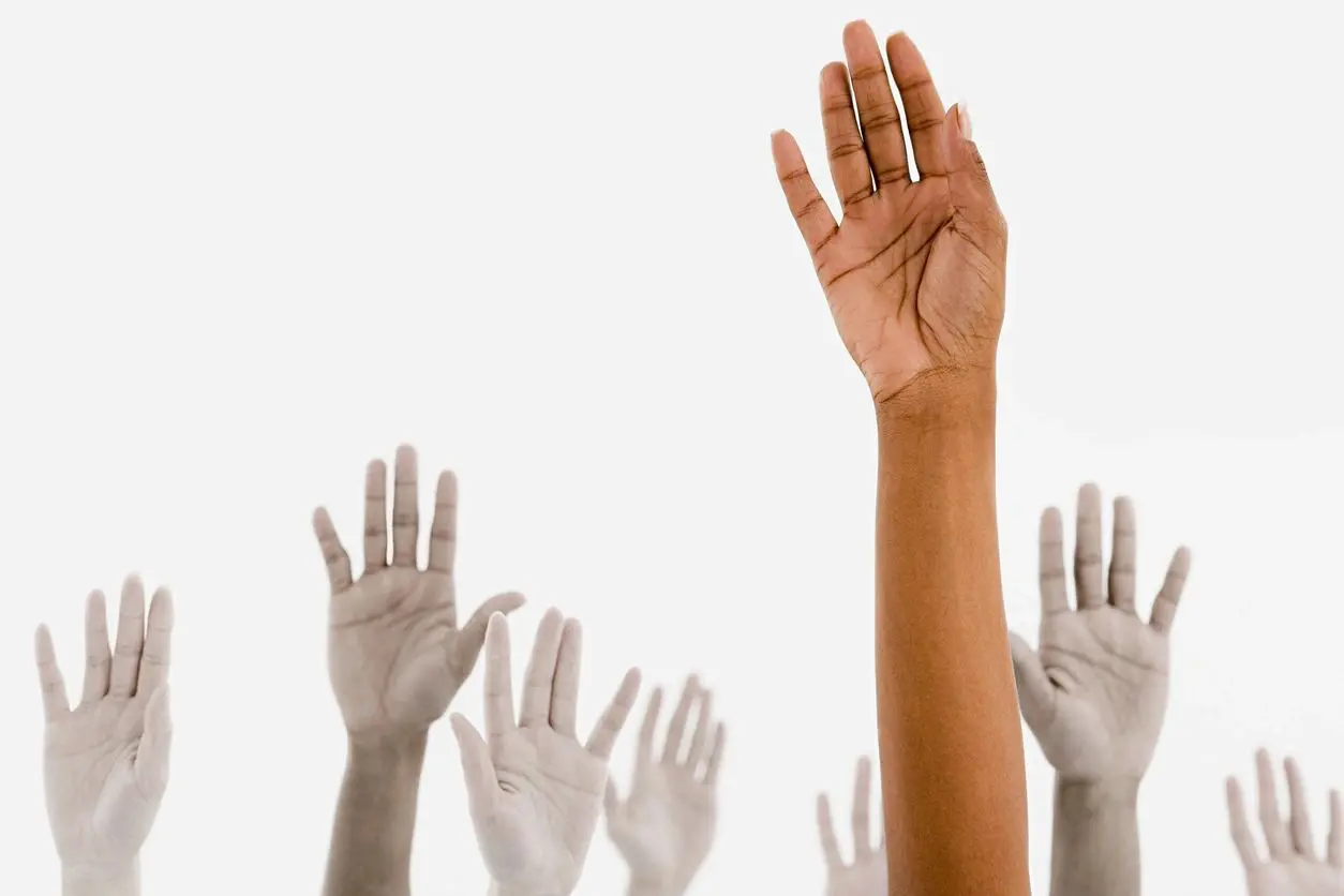 A group of hands raised in the air.